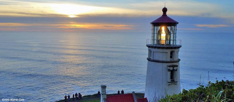 Sunset at Heceta Head Lighthouse, ocean view, and folks watching the sun going down.