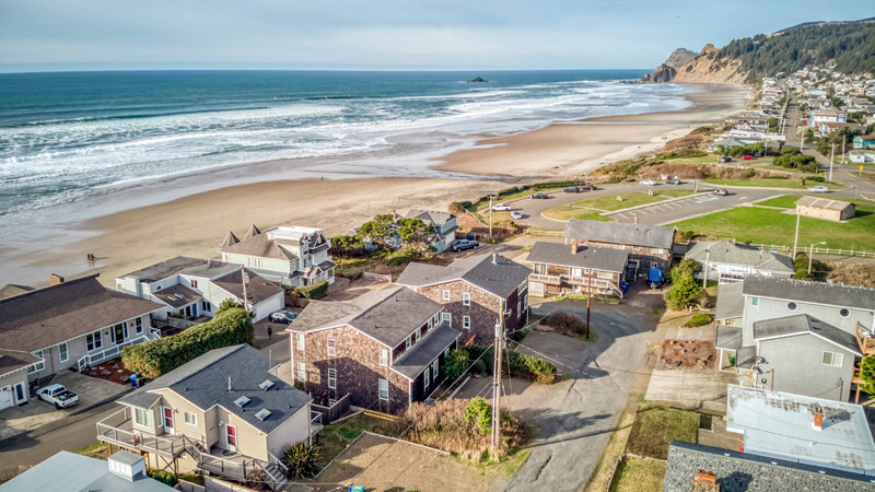 Aerial view overlooking Roads End State Park, the beach, ocean, and neighborhood,
