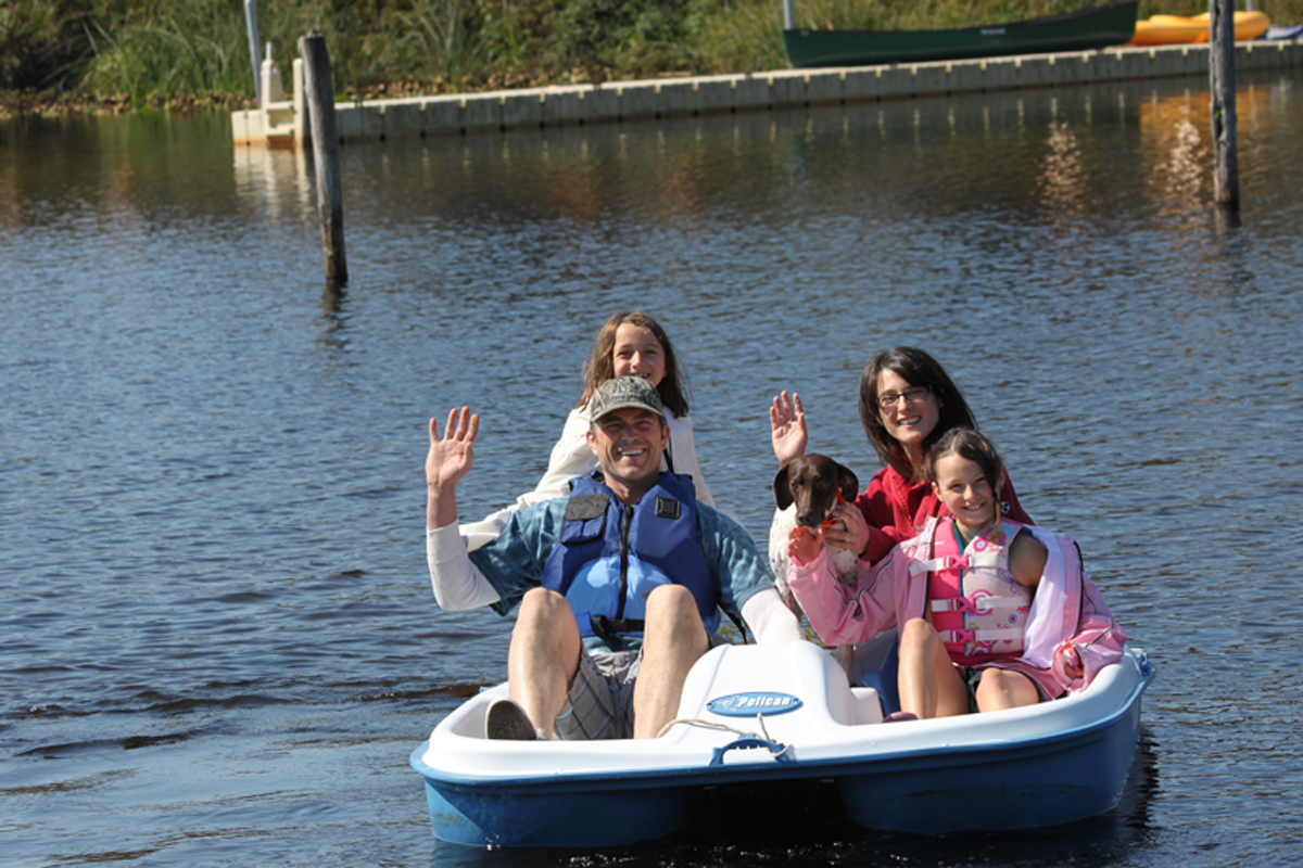 Family paddle boating on Spring Lake from Waterside Family Fun beach rental Rockaway, OR