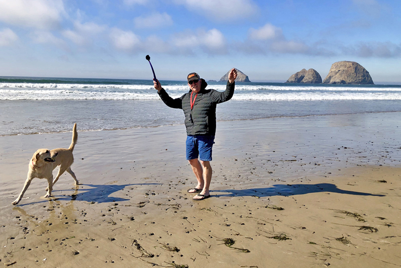 Cooper dog playing ball on the beach in Oceanside, Oregon