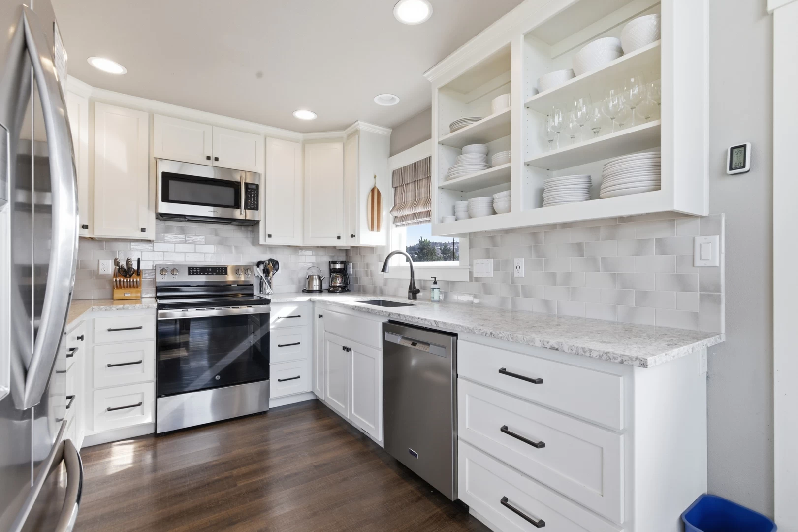 Modern white kitchen with stainless steel appliances